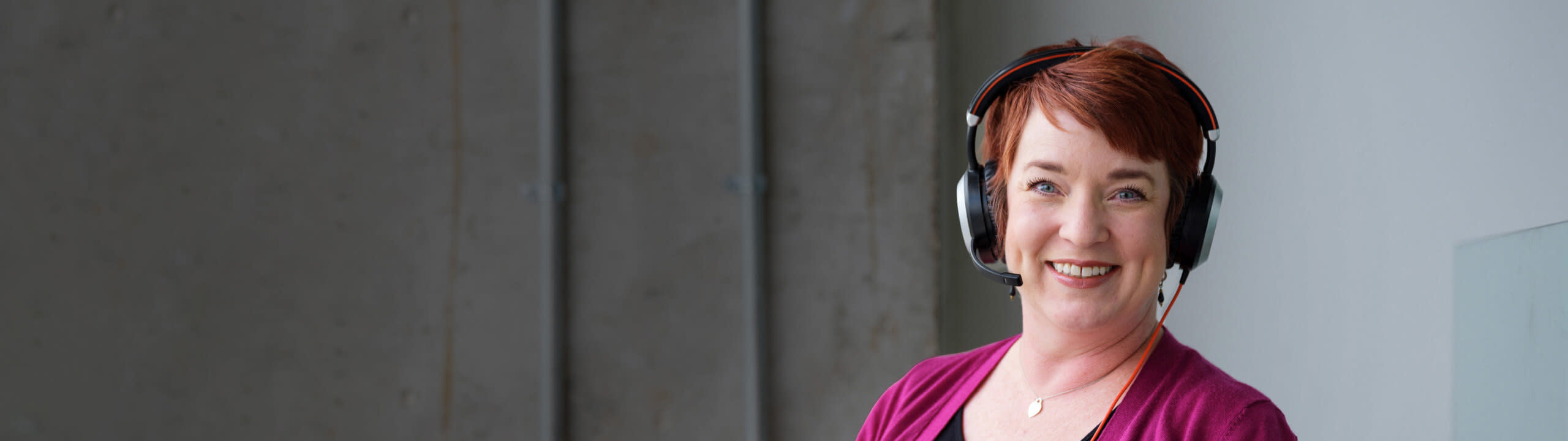 Woman with headphones on smiling to the camera