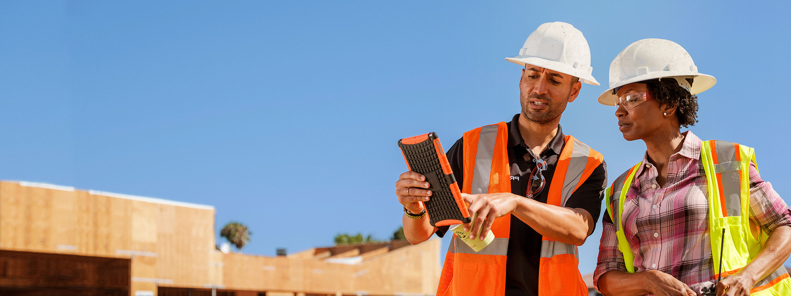 Contractors working with a tablet on the field