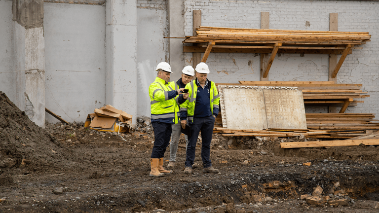 Contractors using Procore on a phone