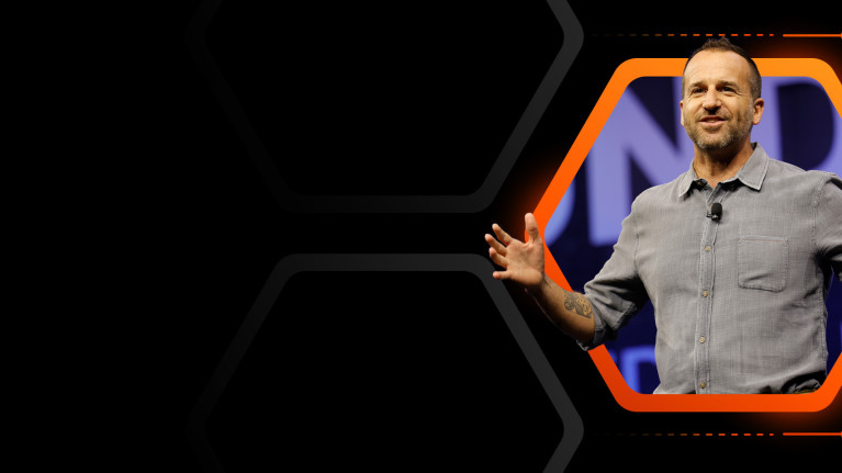 A man speaking on stage at Procore's Groundbreak